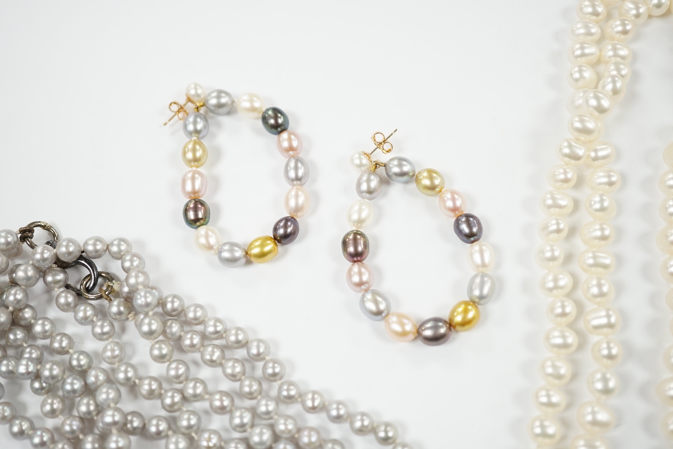 Two freshwater pearl necklaces including double strand, 56cm and a pair of 9ct and multi coloured freshwater pearl earrings.